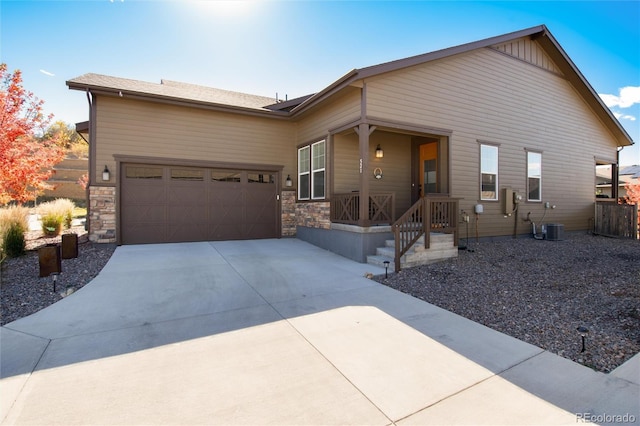 single story home with cooling unit and a garage