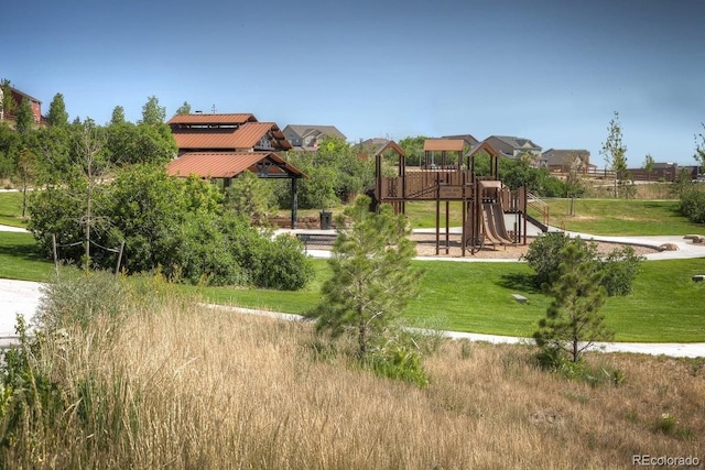 view of jungle gym featuring a lawn