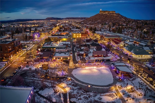 aerial view at dusk featuring a mountain view