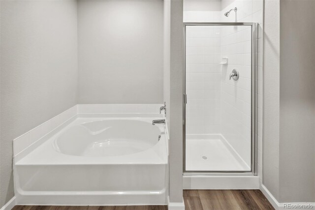 941 Sarah Ave, Fort Lupton, CO 80621 - full bath with a bath, a shower stall, wood finished floors, and baseboards