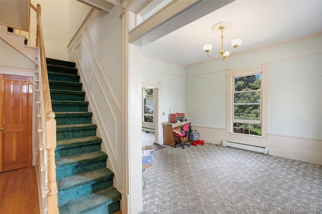 staircase featuring a chandelier, hardwood / wood-style floors, a baseboard radiator, and ornamental molding