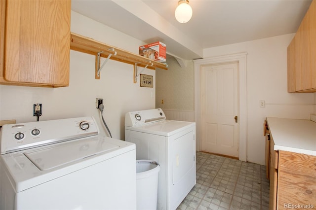 laundry room featuring cabinets and washing machine and dryer