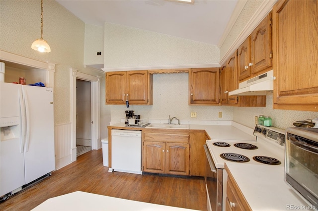 kitchen with white appliances, high vaulted ceiling, sink, hanging light fixtures, and dark hardwood / wood-style floors