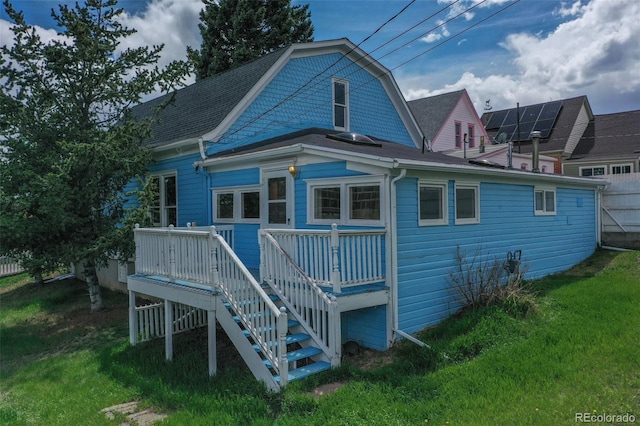 back of property featuring a wooden deck