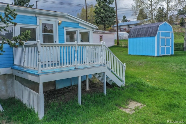 deck with a shed and a yard