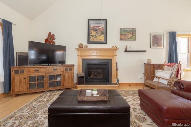 living room featuring light hardwood / wood-style floors and lofted ceiling