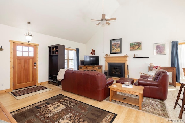 living room with light wood-type flooring, high vaulted ceiling, and ceiling fan