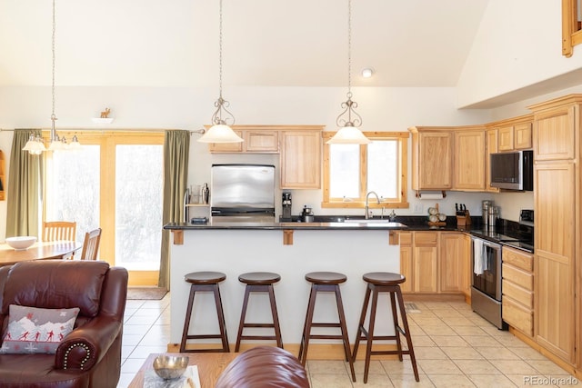 kitchen featuring hanging light fixtures, stainless steel appliances, a notable chandelier, lofted ceiling, and light tile patterned floors