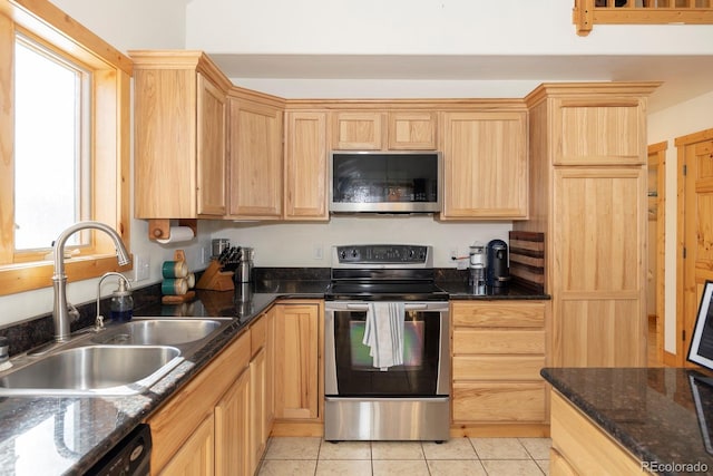 kitchen with a wealth of natural light, sink, stainless steel appliances, and light brown cabinets