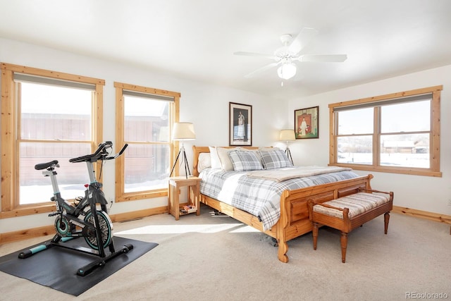 carpeted bedroom with ceiling fan and multiple windows