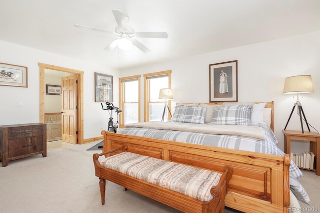 bedroom featuring radiator, ensuite bathroom, ceiling fan, and light carpet