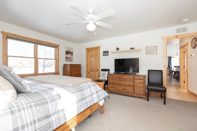 bedroom featuring ceiling fan and light carpet