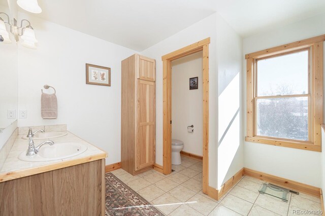 bathroom featuring tile patterned flooring, vanity, and toilet