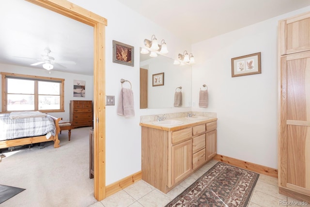 bathroom with tile patterned flooring, vanity, and ceiling fan