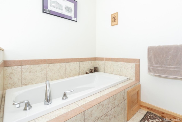 bathroom featuring tiled tub