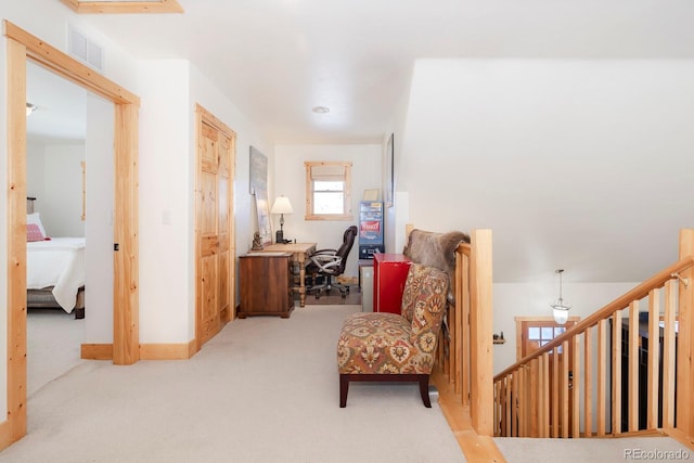 sitting room featuring light carpet