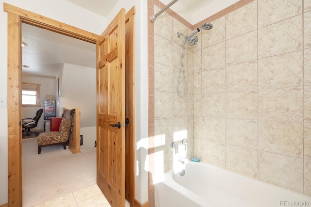 bathroom with tile patterned floors and tiled shower / bath