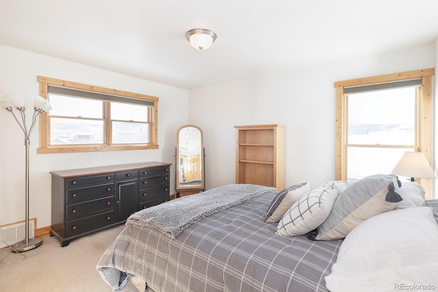 carpeted bedroom featuring multiple windows