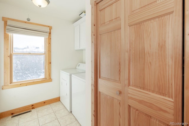 washroom with cabinet space, visible vents, baseboards, independent washer and dryer, and light tile patterned flooring