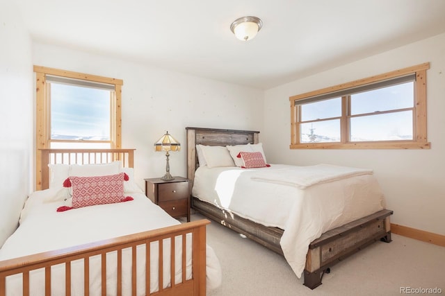 bedroom featuring baseboards and light colored carpet