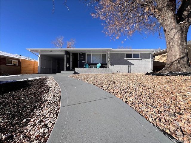 ranch-style home featuring a carport