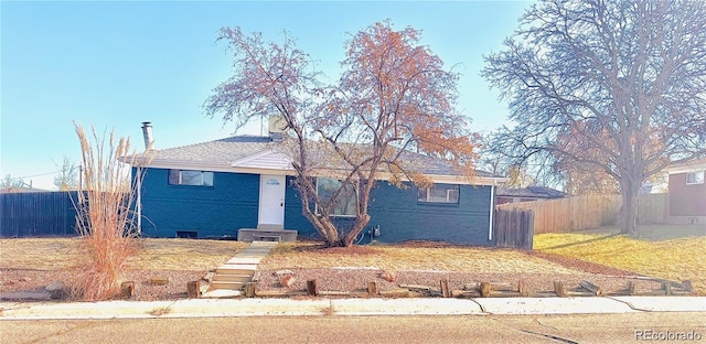 view of front of home with brick siding and fence