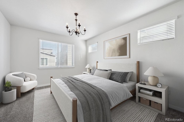 bedroom with a notable chandelier, baseboards, and carpet