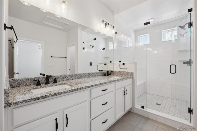 full bath with tile patterned floors, double vanity, a shower stall, and a sink