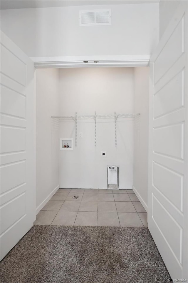 clothes washing area featuring visible vents, light tile patterned floors, laundry area, hookup for a washing machine, and hookup for an electric dryer