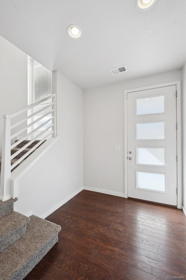 entryway with baseboards, visible vents, recessed lighting, stairs, and wood-type flooring