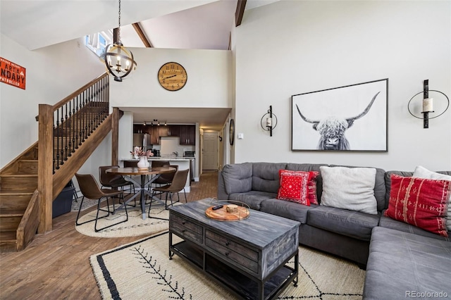 2449 Ryan Gulch Ct Unit 2449, Silverthorne, CO 80498 - living room with a chandelier, stairway, a towering ceiling, and wood finished floors