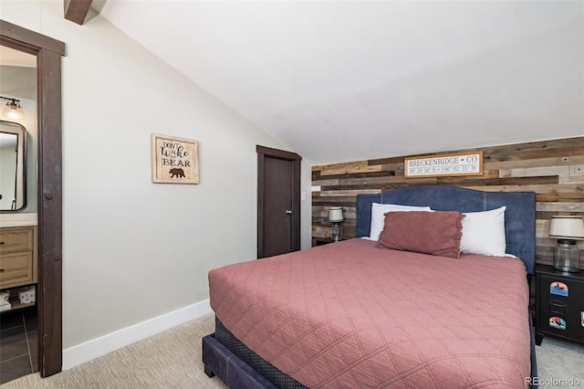 2449 Ryan Gulch Ct Unit 2449, Silverthorne, CO 80498 - bedroom featuring wooden walls, lofted ceiling, carpet floors, and connected bathroom