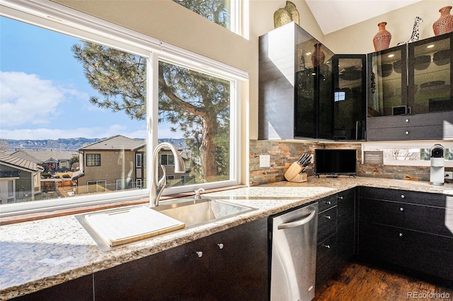 kitchen featuring dark wood-style floors, a wealth of natural light, vaulted ceiling, and a sink