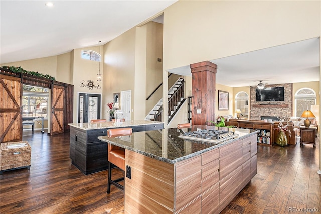 kitchen featuring dark wood-type flooring, a kitchen island, and a wealth of natural light