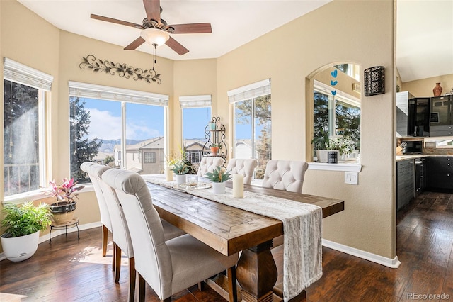 dining area with dark wood-style floors, baseboards, and a ceiling fan