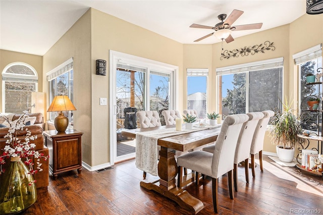 dining space with dark wood-style floors, ceiling fan, visible vents, and baseboards