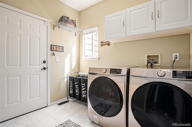 laundry room with marble finish floor, independent washer and dryer, cabinet space, and baseboards