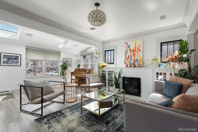 561 Cook St, Denver, CO 80206 - living room with a skylight, wood finished floors, a glass covered fireplace, lofted ceiling, and ornamental molding