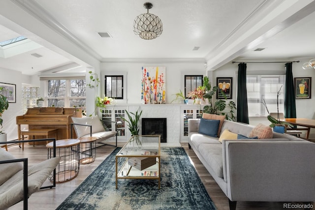 561 Cook St, Denver, CO 80206 - living area featuring a glass covered fireplace, wood finished floors, and ornamental molding