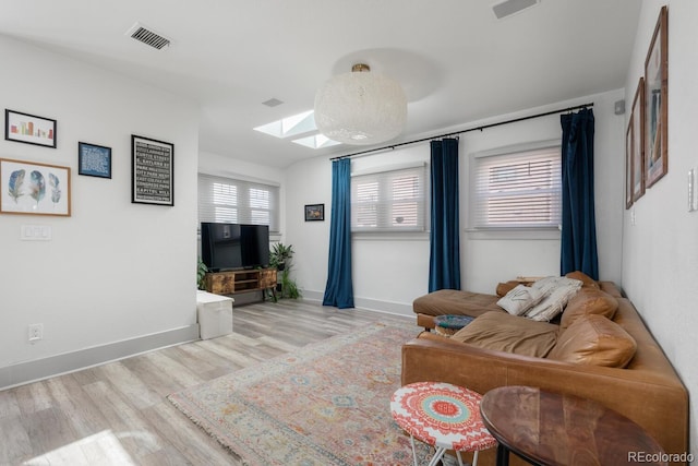 561 Cook St, Denver, CO 80206 - living area featuring wood finished floors, a skylight, and baseboards
