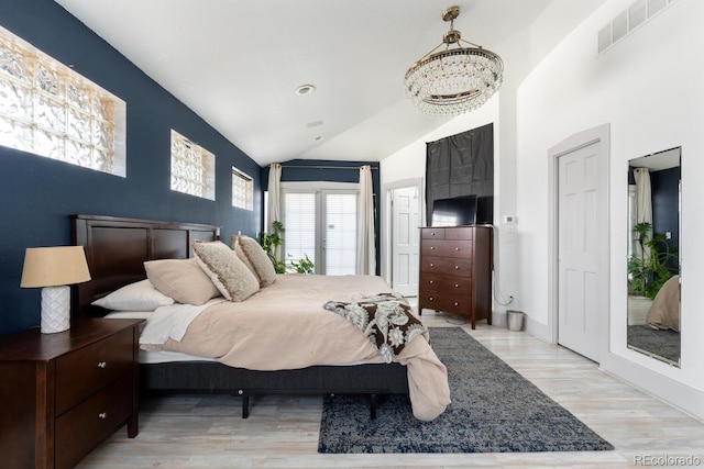 561 Cook St, Denver, CO 80206 - bedroom featuring vaulted ceiling, wood finished floors, and a chandelier