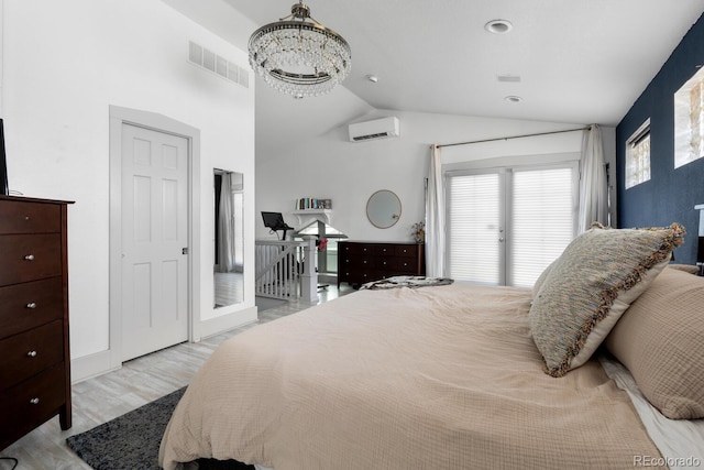 561 Cook St, Denver, CO 80206 - bedroom with a wall mounted AC, vaulted ceiling, light wood-style flooring, and a chandelier