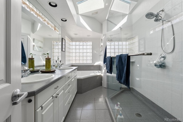 561 Cook St, Denver, CO 80206 - full bath featuring tile patterned floors, a skylight, a bath, a shower stall, and double vanity