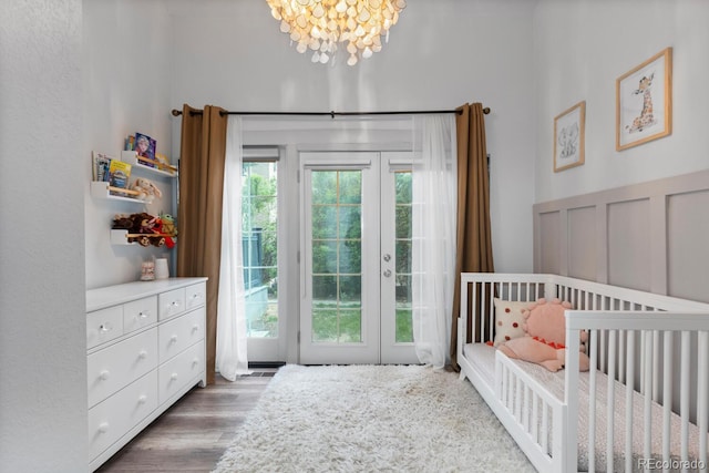 561 Cook St, Denver, CO 80206 - bedroom featuring french doors, a chandelier, wood finished floors, and access to outside