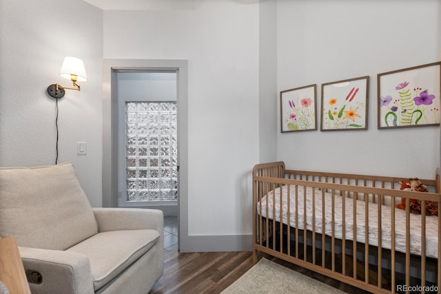 561 Cook St, Denver, CO 80206 - bedroom with wood finished floors, baseboards, and a nursery area