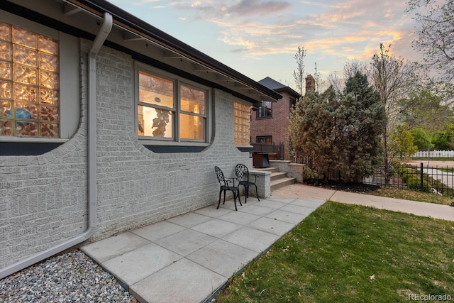 561 Cook St, Denver, CO 80206 - view of side of home with brick siding, a patio area, and a chimney