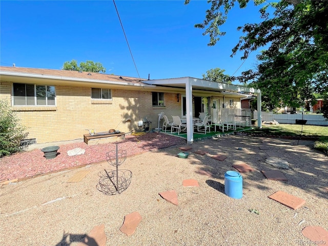 6236 Ingalls Ct, Arvada, CO 80003 - back of house with brick siding and a patio