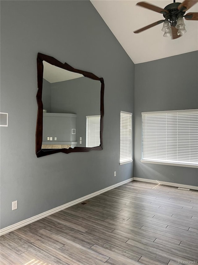 spare room featuring ceiling fan, high vaulted ceiling, and hardwood / wood-style floors