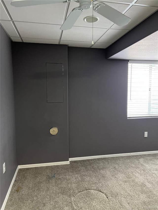 spare room featuring ceiling fan, carpet flooring, and a drop ceiling