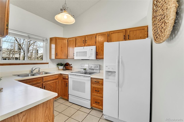 kitchen with hanging light fixtures, a sink, white appliances, light countertops, and light tile patterned floors
